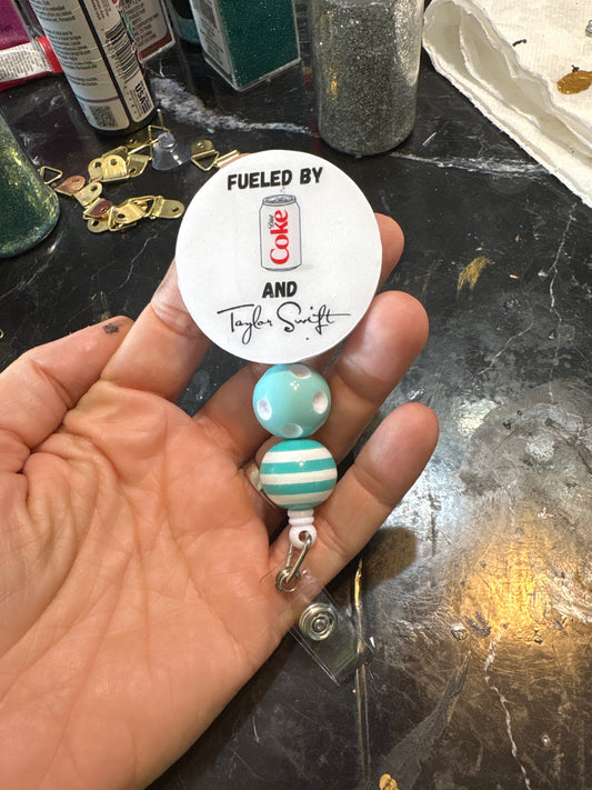 Diet Coke and Taylor badge reel